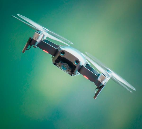 Quarterly Newsletter December 2021 dronetec innovation article showing a grey drone flying on a green background